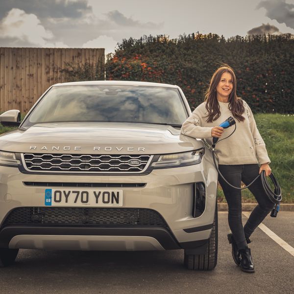 Ginny Buckley with cable next to Range Rover electric car