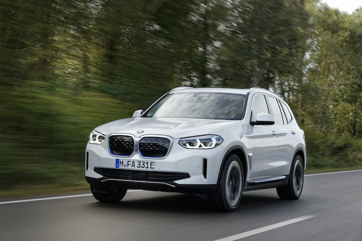 BMW iX3 exterior front driving in country
