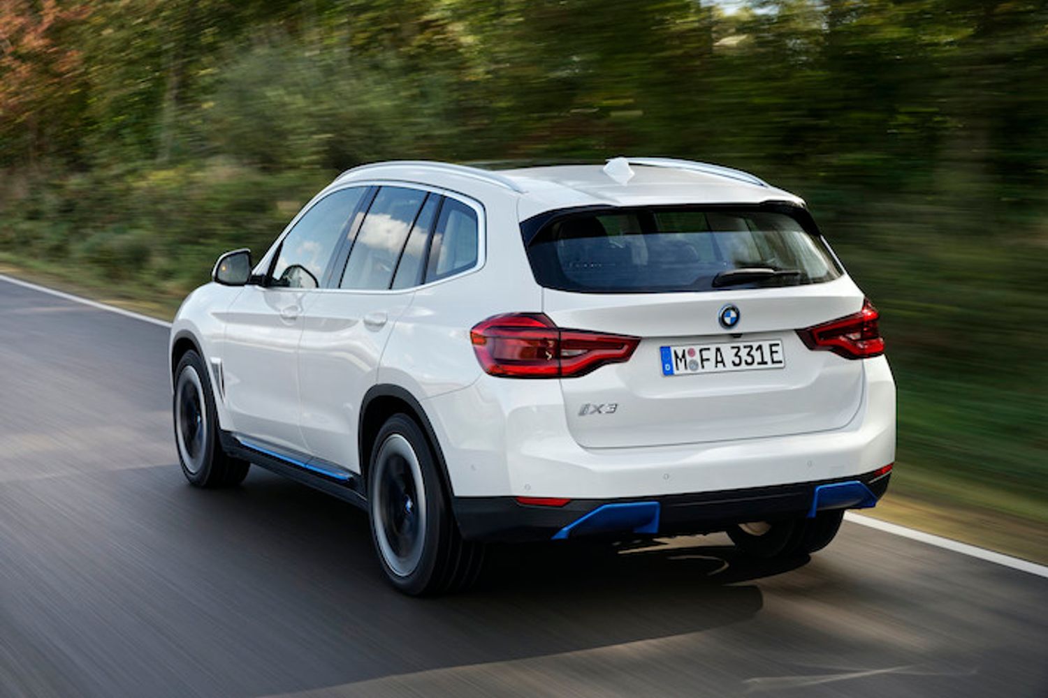 BMW iX3 exterior rear driving in country