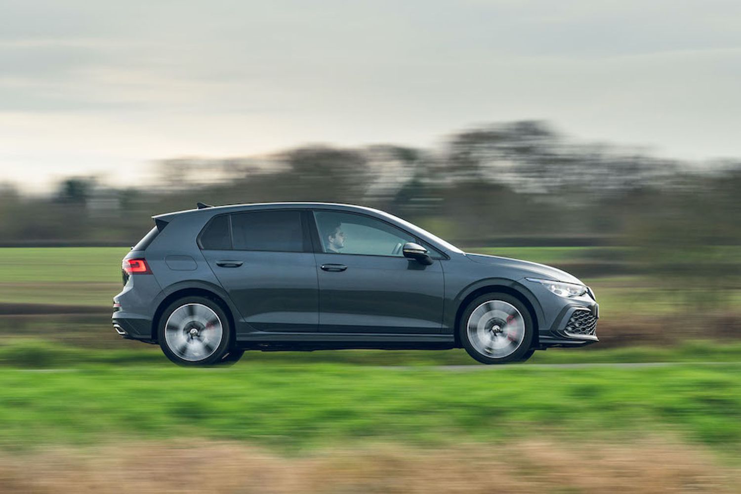 VW Golf GTE PHEV exterior side driving in country
