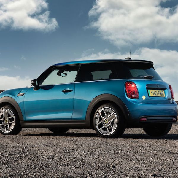 2021 MINI Electric rear tracking static shot, blue car, in countryside, parked on gravel