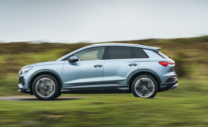 Audi Q4 e-tron side action shot, straight road in countryside, blue/silver car, RHD, UK plates