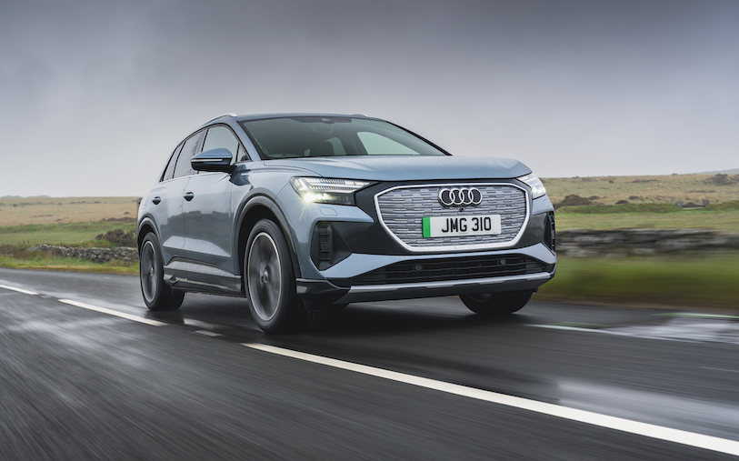 Audi Q4 e-tron front action shot, straight road in countryside, blue/silver car, RHD, UK plates