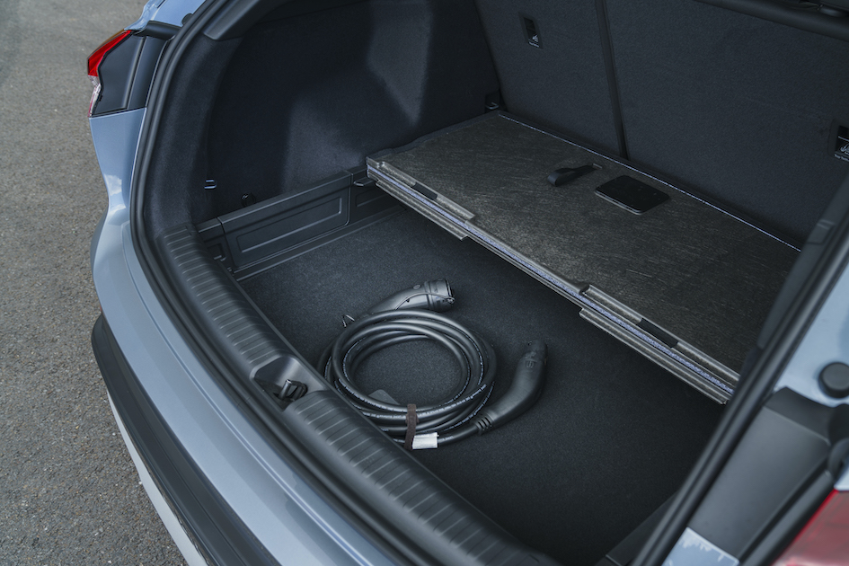 Audi Q4 e-tron boot space showing cable storage under floor, blue/silver car