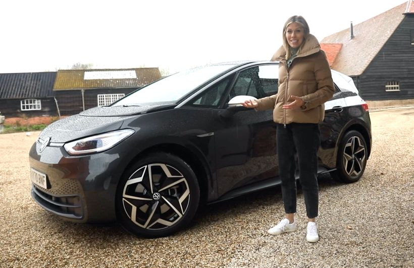 VW ID.3 static shot, black car in a quartyard with presenter Nicki Shields