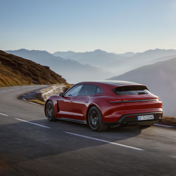 Porsche Taycan Sport Turismo, red, rear action shot on mountain road
