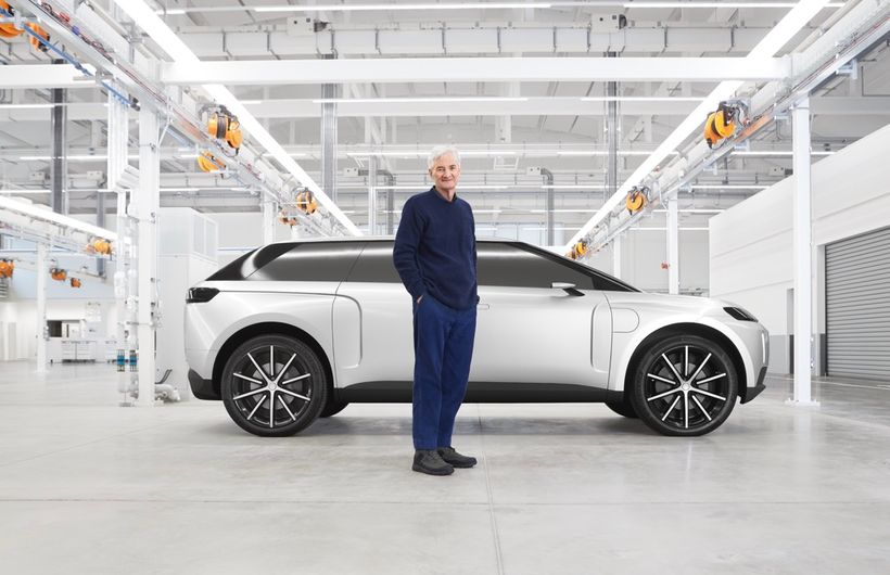 Dyson electric car, silver, side on, in workshop, with James Dyson