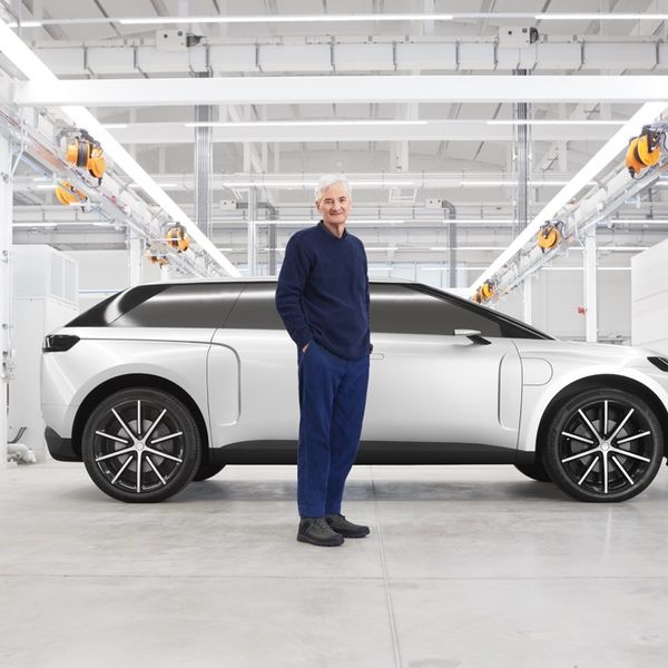 Dyson electric car, silver, side on, in workshop, with James Dyson