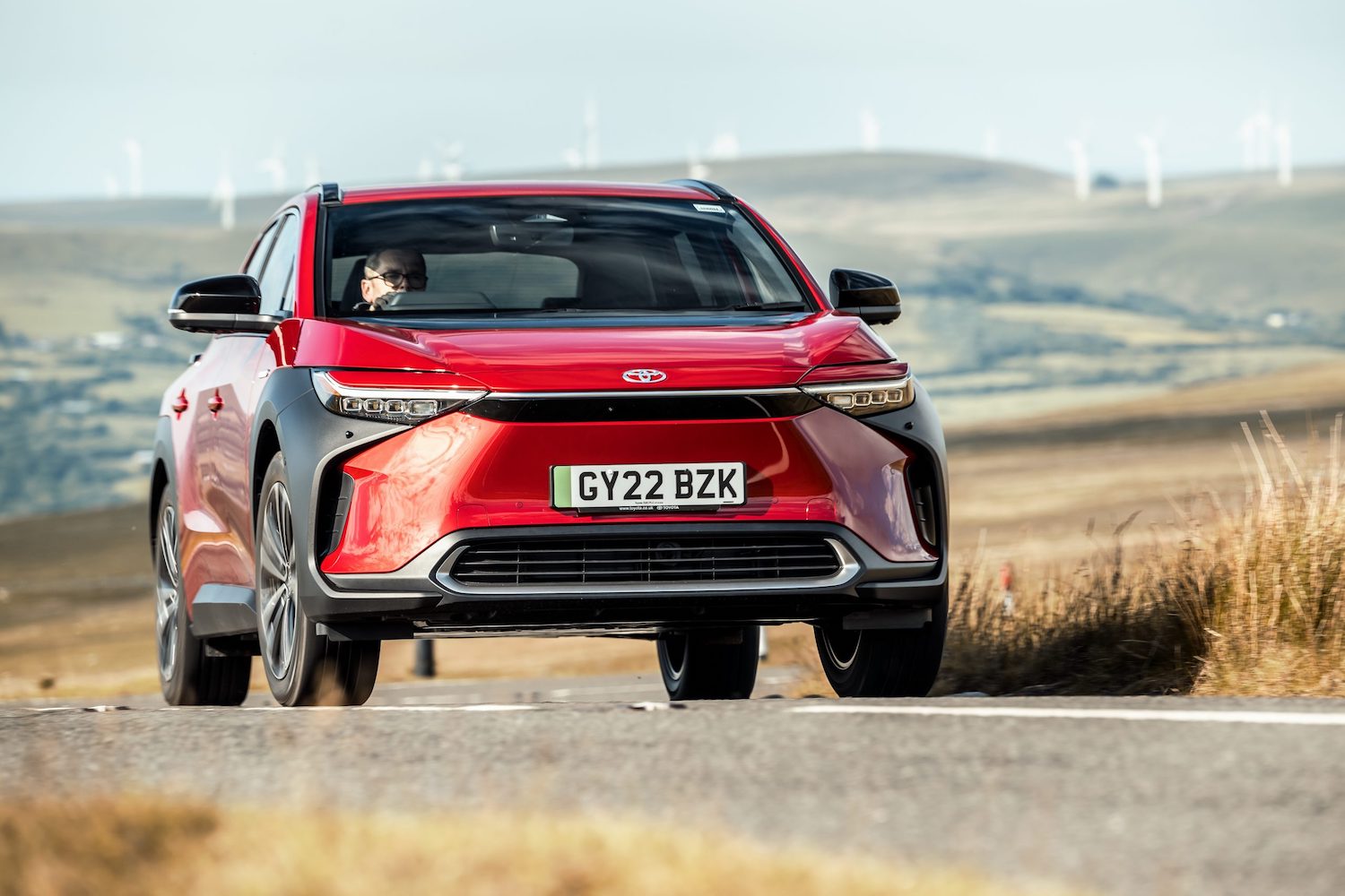 Toyota bZ4x action, front, red car, RHD UK registration