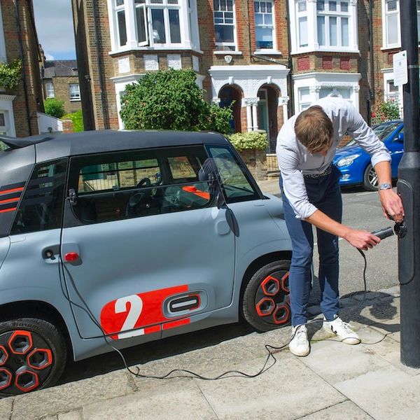 Citroen Ami in UK, being plugged in to ubitricity charge point on a lamp post in street