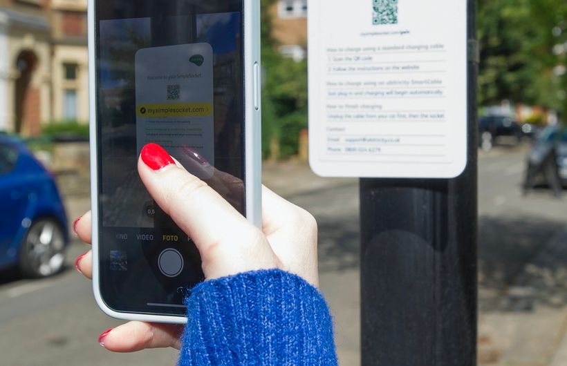 Ubitricity charge point app being used by person with smartphone in UK