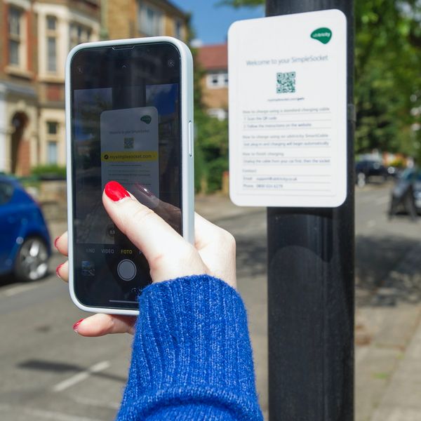 Ubitricity charge point app being used by person with smartphone in UK