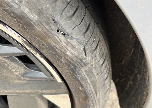 Cupra Born burst tyre puncture, close up, damaged alloy wheel