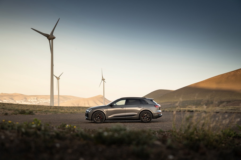 Audi Q8 e-tron static shot, green car,  left hand drive, wind turbines in background