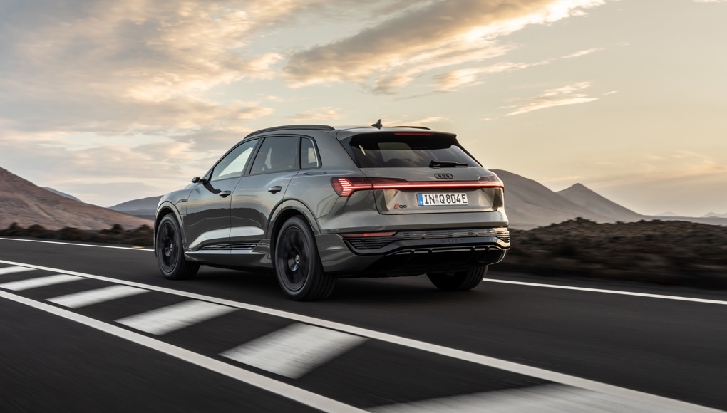 Audi Q8 e-tron rear tracking action shot, green car,  left hand drive car